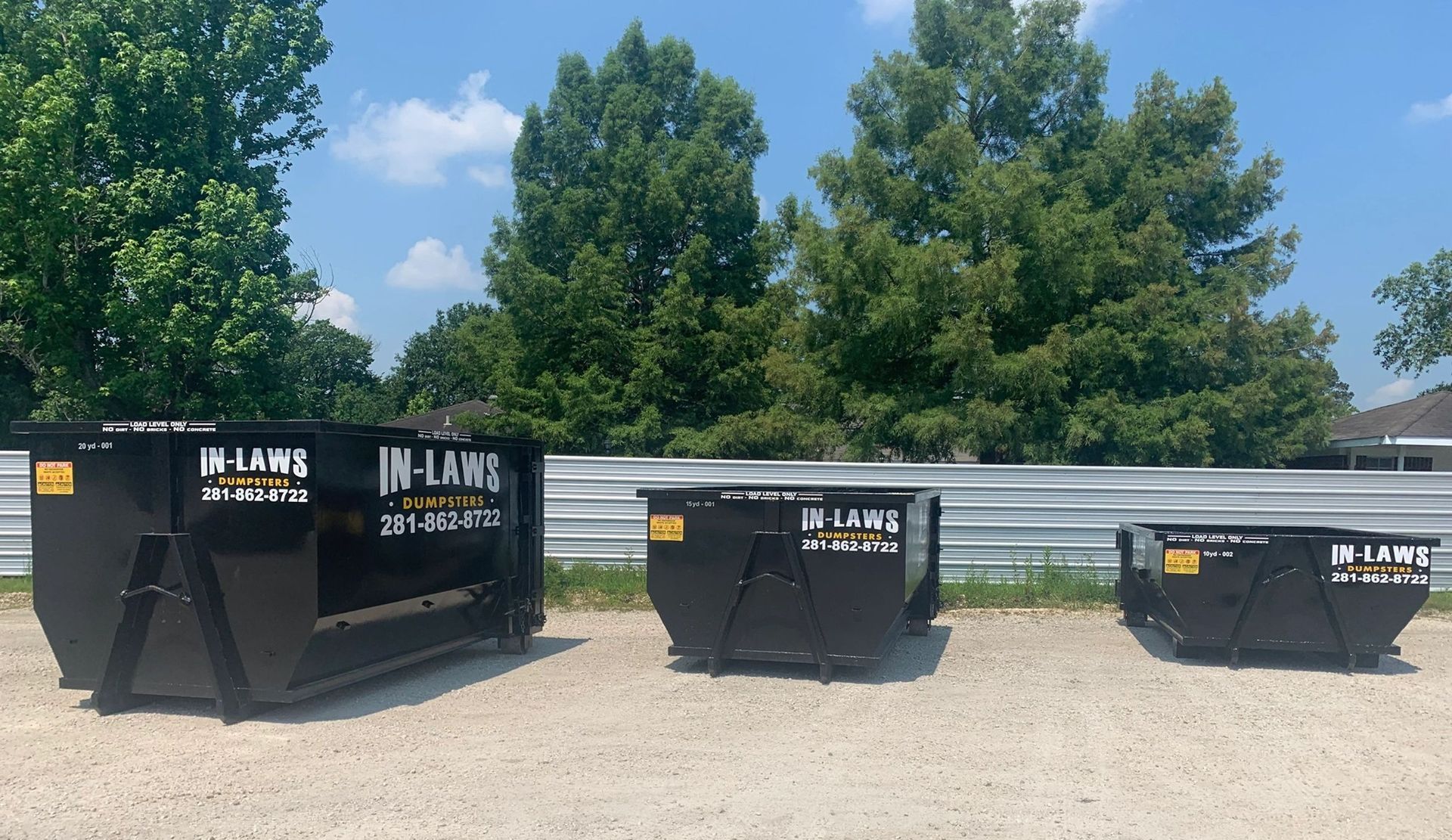 Three dumpsters with the word inland on them