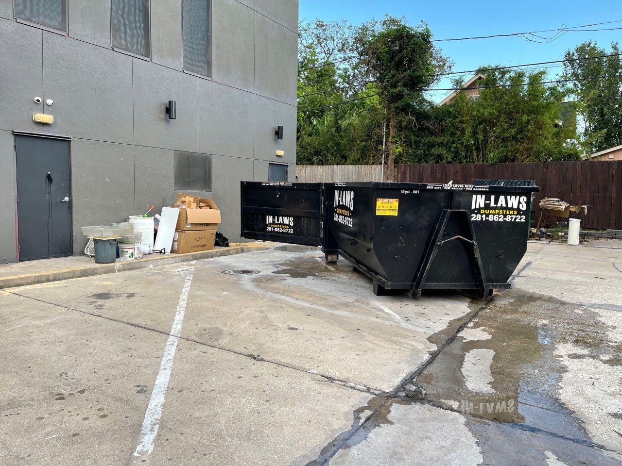 A dumpster with the word in law on it