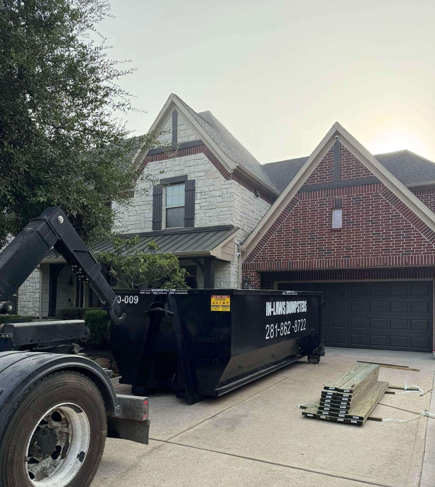 A photo of a 20 yard dumpster rental in Houston, TX, from In-Laws Services assisting with a remodel.