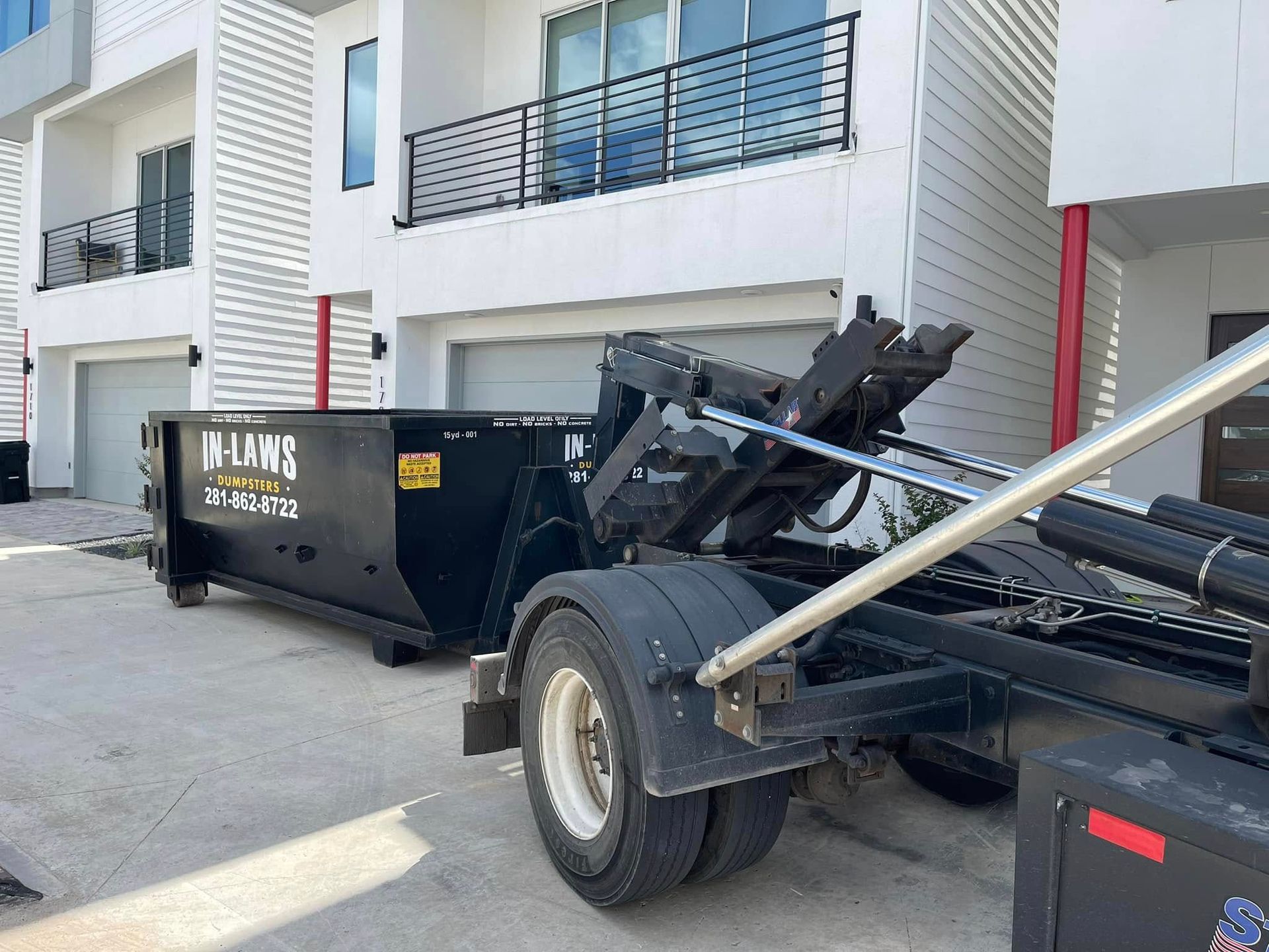 In-Laws roll-off dumpster set in a Houston driveway for a remodel
