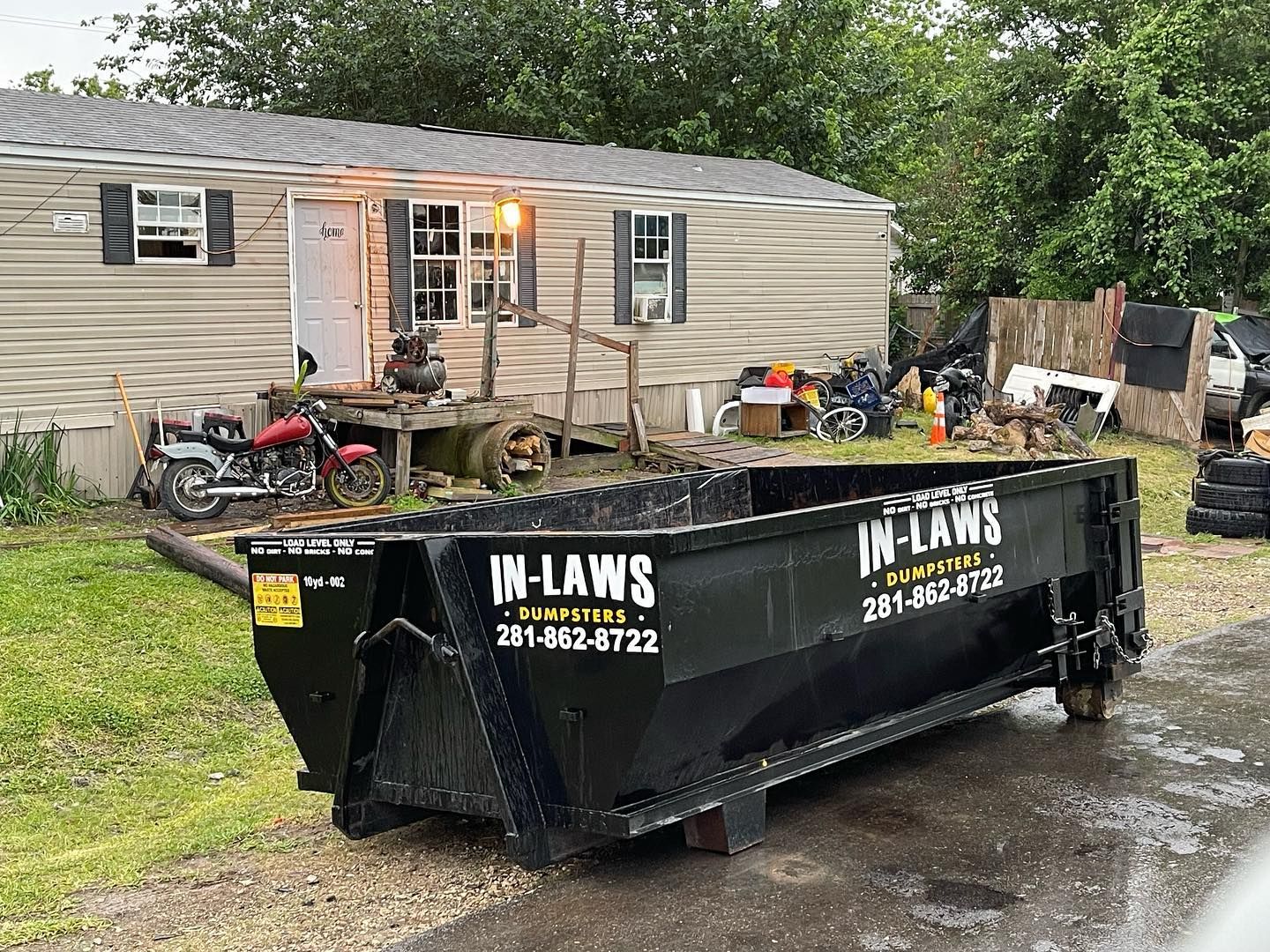 A photo of a home in Houston, TX, with a dumpster rental to complete their spring cleaning checklist