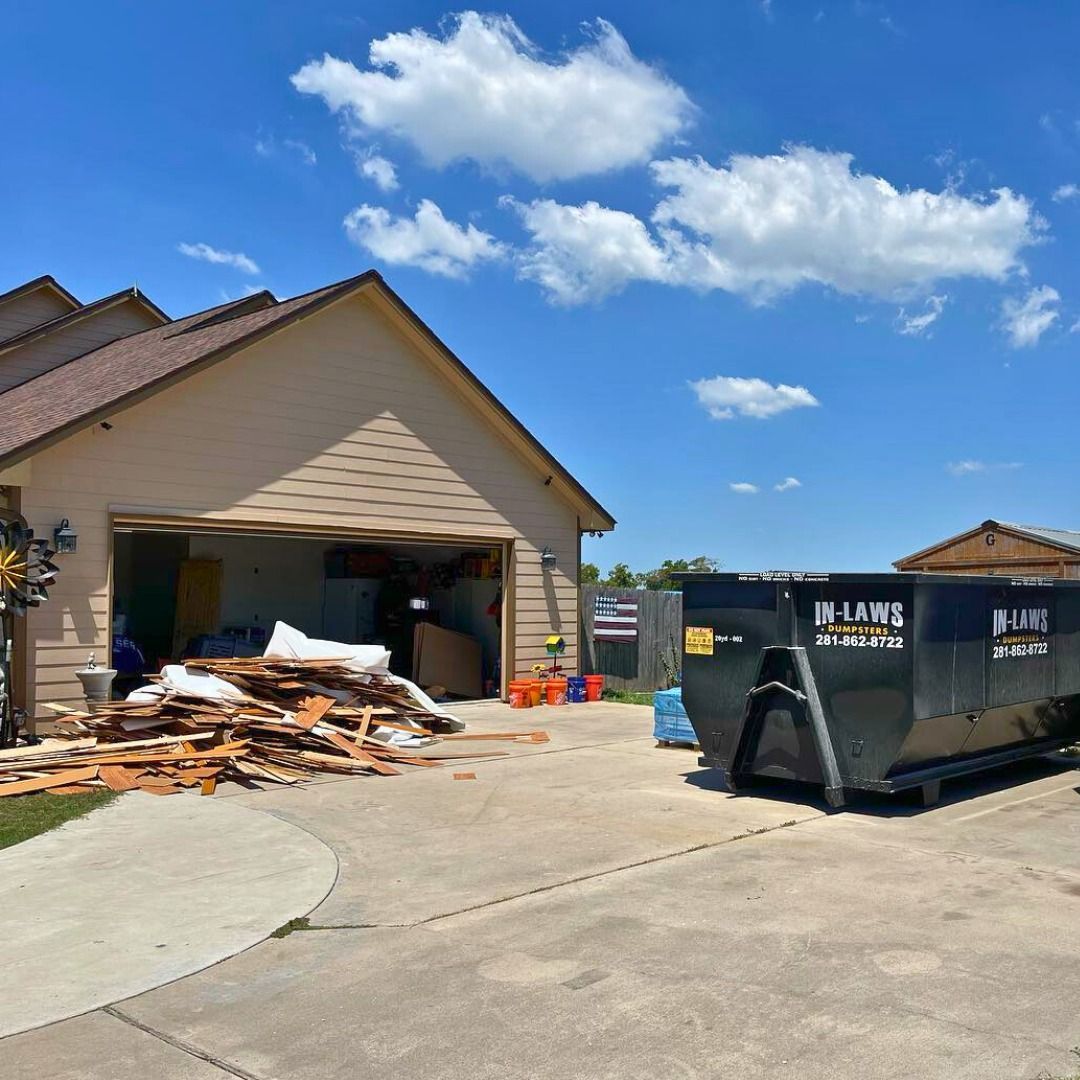 A house with a dumpster in front of it that says j-land