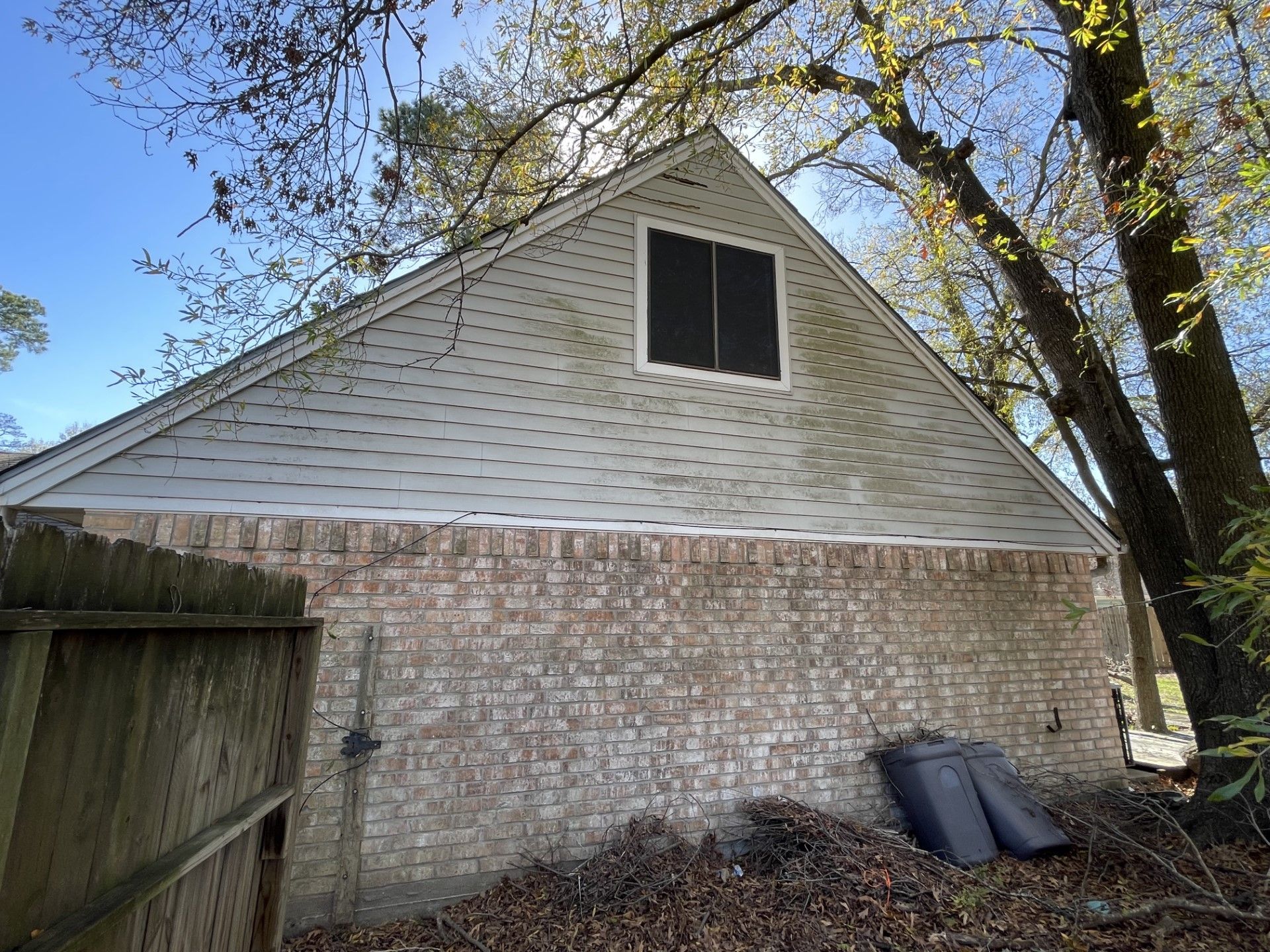 A brick building with a roof that has a window on it.