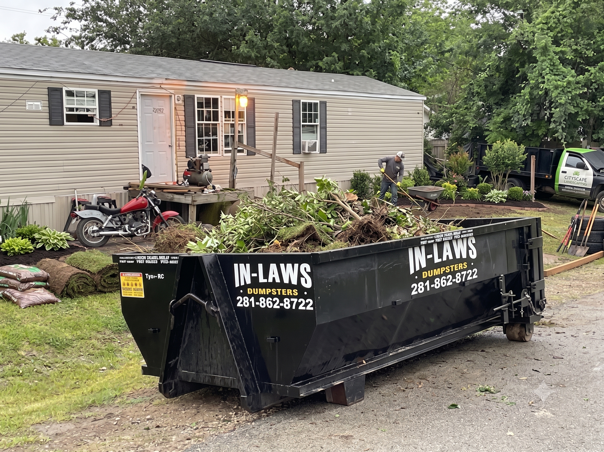 A photo of a dumpster rental from In-Laws Services assisting in a yard debris cleanup in Houston, TX