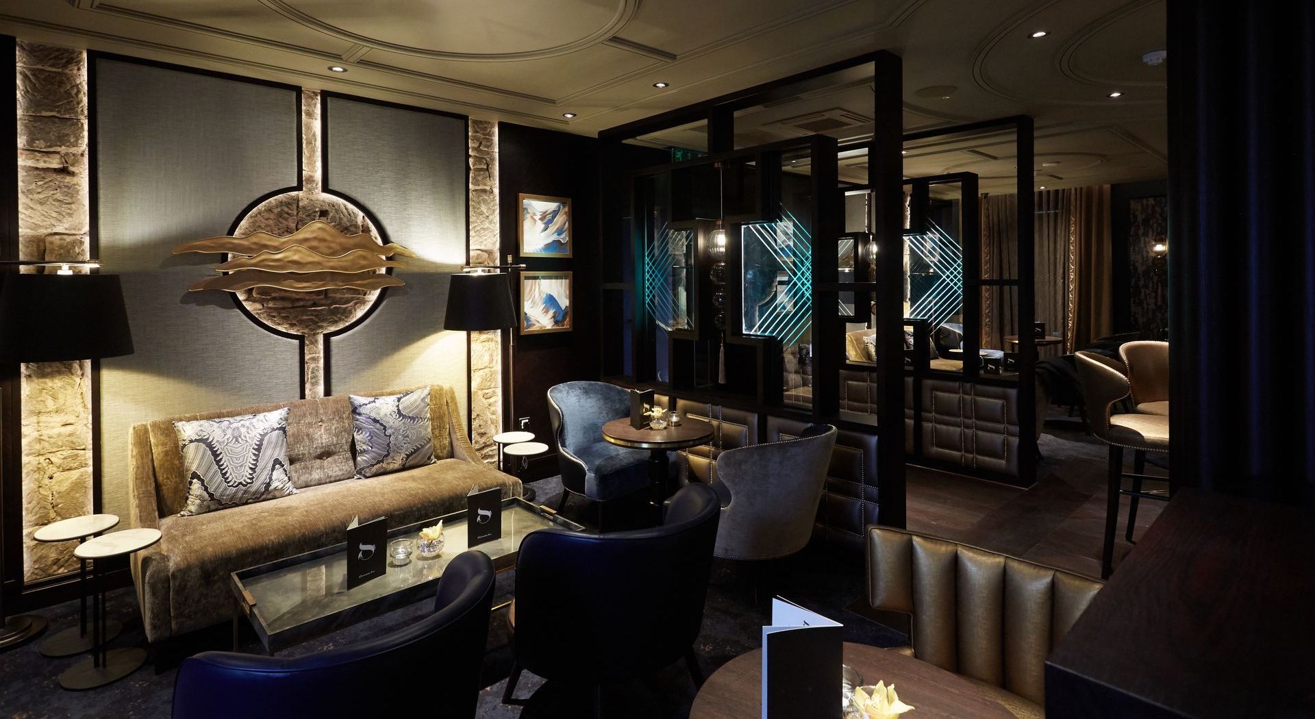 Sitting area in champagne bar in La Dragon with a sofa and soft seating. 