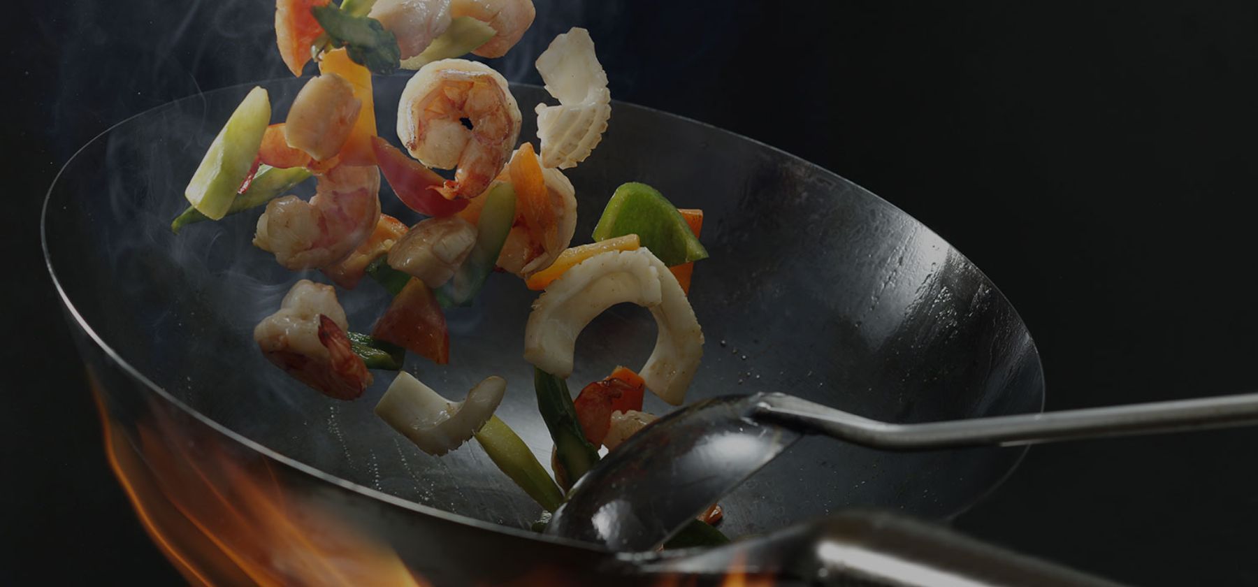 stir fry being cooked in a wok