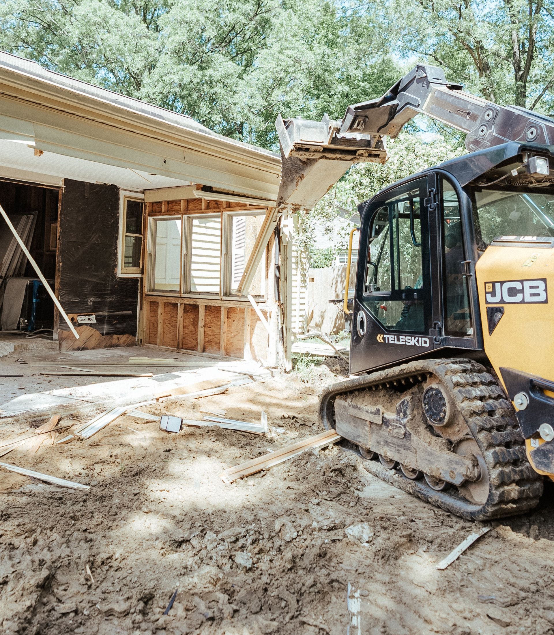 A bulldozer is being used to demolish a house.