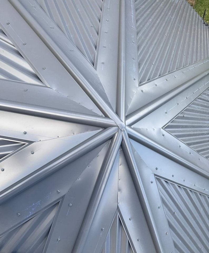 Silver Metal Roof With a Star-shaped Design, Featuring Ridges and Rivets — Rumara Roofing in Caboolture, QLD