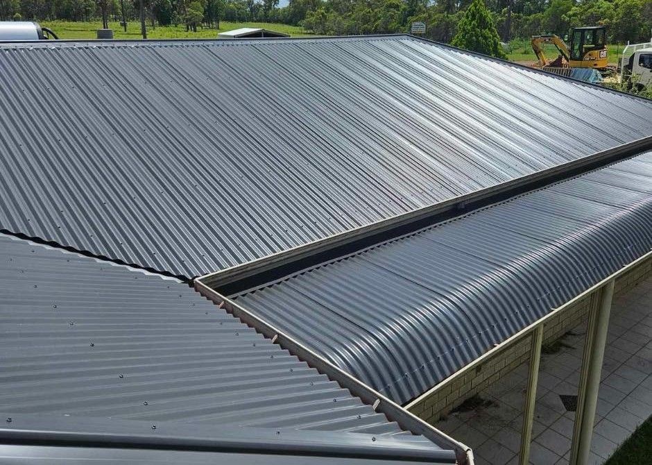 Gray Metal Roofs on a Building, With a Slight Curve on the Lower Edge, and Gutters — Rumara Roofing Pty Ltd in Sunshine Coast, QLD
