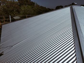 Silver Corrugated Metal Roof, Angled Perspective, Shadows, and Natural Light — Rumara Roofing in Sunshine Coast, QLD
