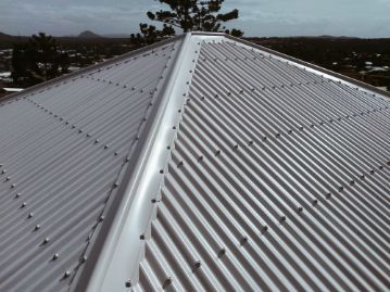 Close-up of a White Metal Roof With Many Visible Rivets. the Roof is Peaked — Rumara Roofing in Sunshine Coast, QLD