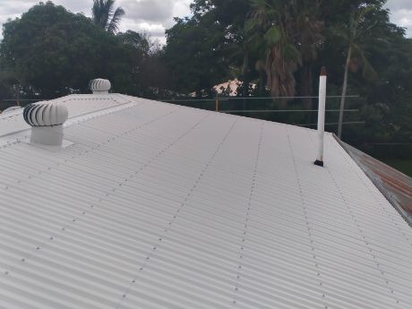 White Corrugated Metal Roof With Vents, Trees in Background — Rumara Roofing in Sunshine Coast, QLD