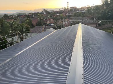 Metal Corrugated Roof With a Skyline View in the Background, Golden Hour — Rumara Roofing in Sunshine Coast, QLD