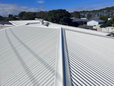 White Metal Roof With Ridges and Central Gutter, Sunny Outdoor Setting — Rumara Roofing in Sunshine Coast, QLD