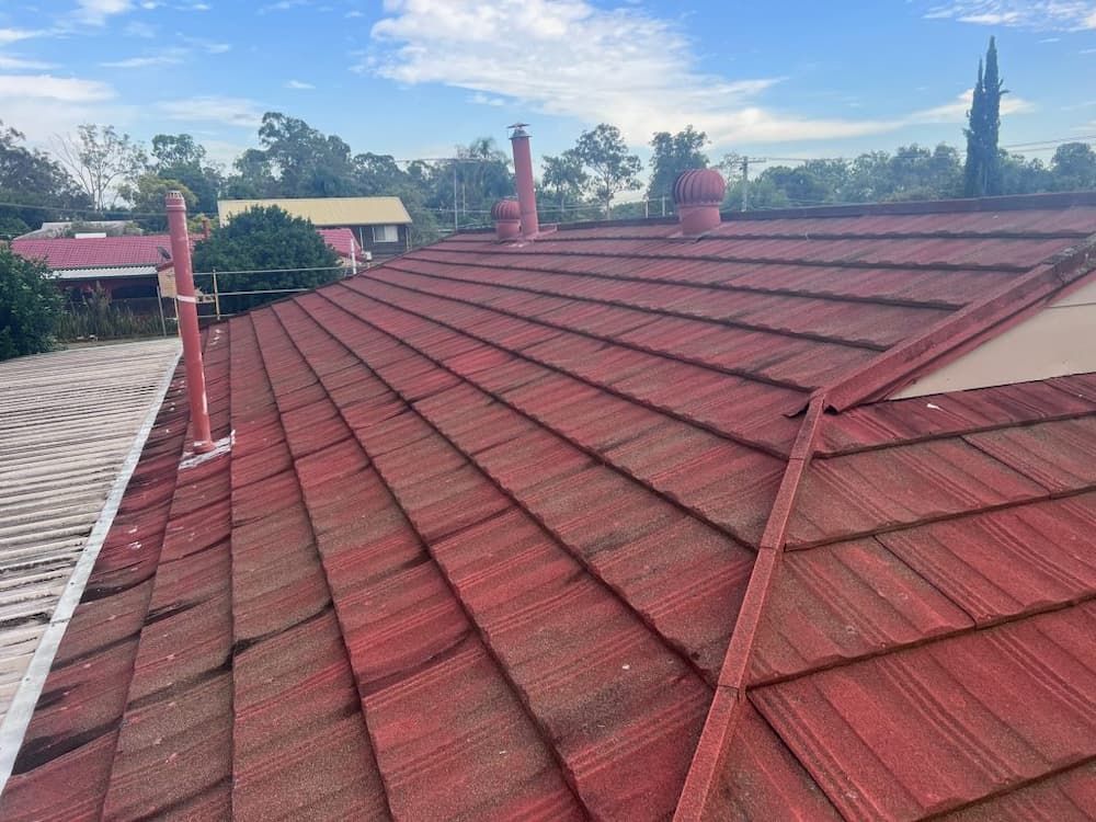 Red Tiled Roof With Chimneys and Vents — Rumara Roofing in Sunshine Coast, QLD