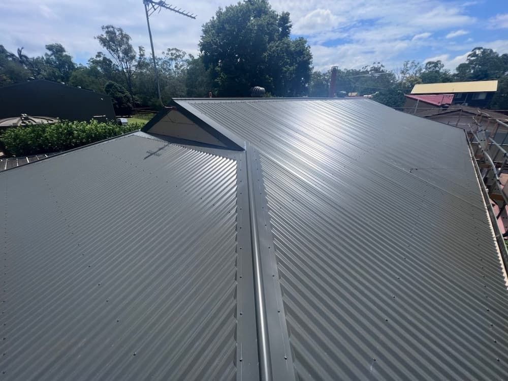Gray Corrugated Metal Roof of a House — Rumara Roofing in Sunshine Coast, QLD