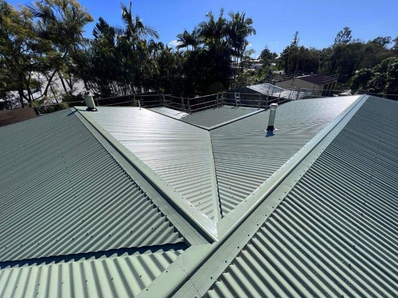 Green Corrugated Metal Roof With Safety Railing, Sunny Day — Rumara Roofing Pty Ltd in Noosa, QLD