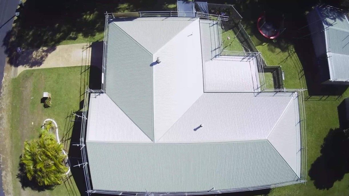 Overhead View of a House With a Green-grey Metal Roof and Green Lawn — Rumara Roofing Pty Ltd in Noosa, QLD