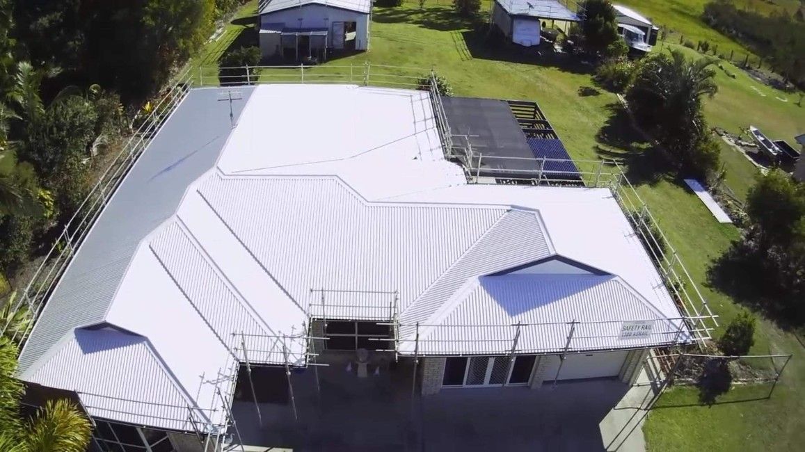 Aerial View of a House With a White Metal Roof Under Construction — Rumara Roofing Pty Ltd in Noosa, QLD