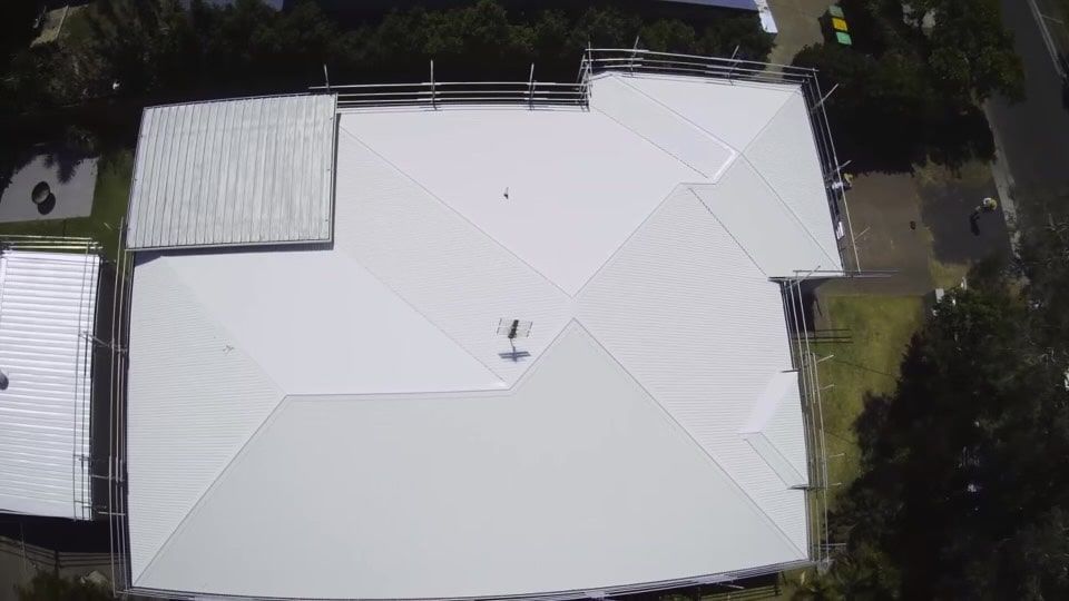 Overhead View of a White Metal Roof on a House, With Scaffolding Around Edges — Rumara Roofing in Sunshine Coast, QLD