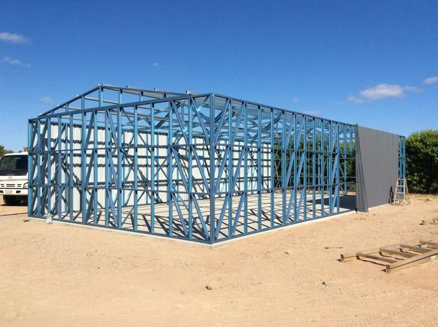 Blue Steel Building Frame Under Construction on A Sandy Lot — Bridgey's Constructions in Wallabi Point, NSW