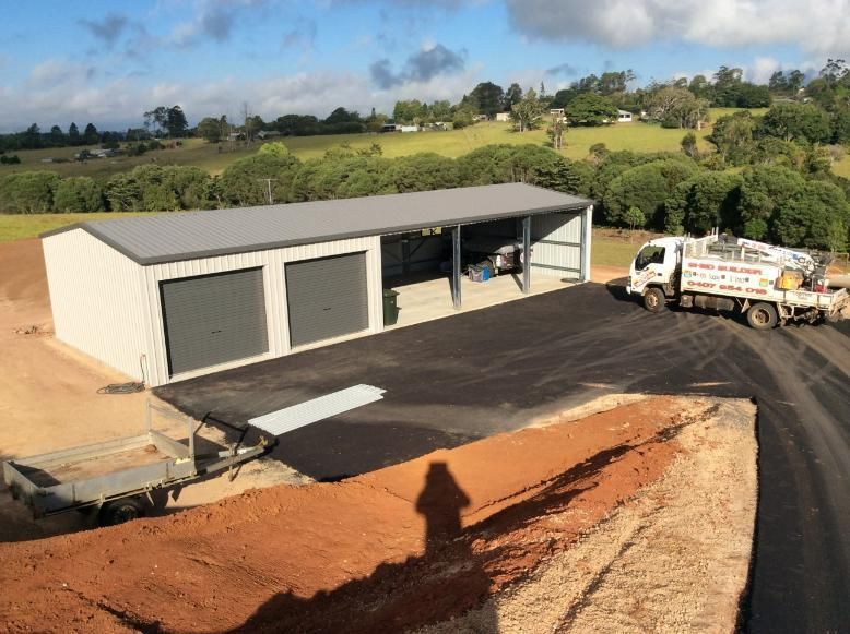 A Grey Metal Shed With Two Garage Doors  — Bridgey's Constructions in Wallabi Point, NSW