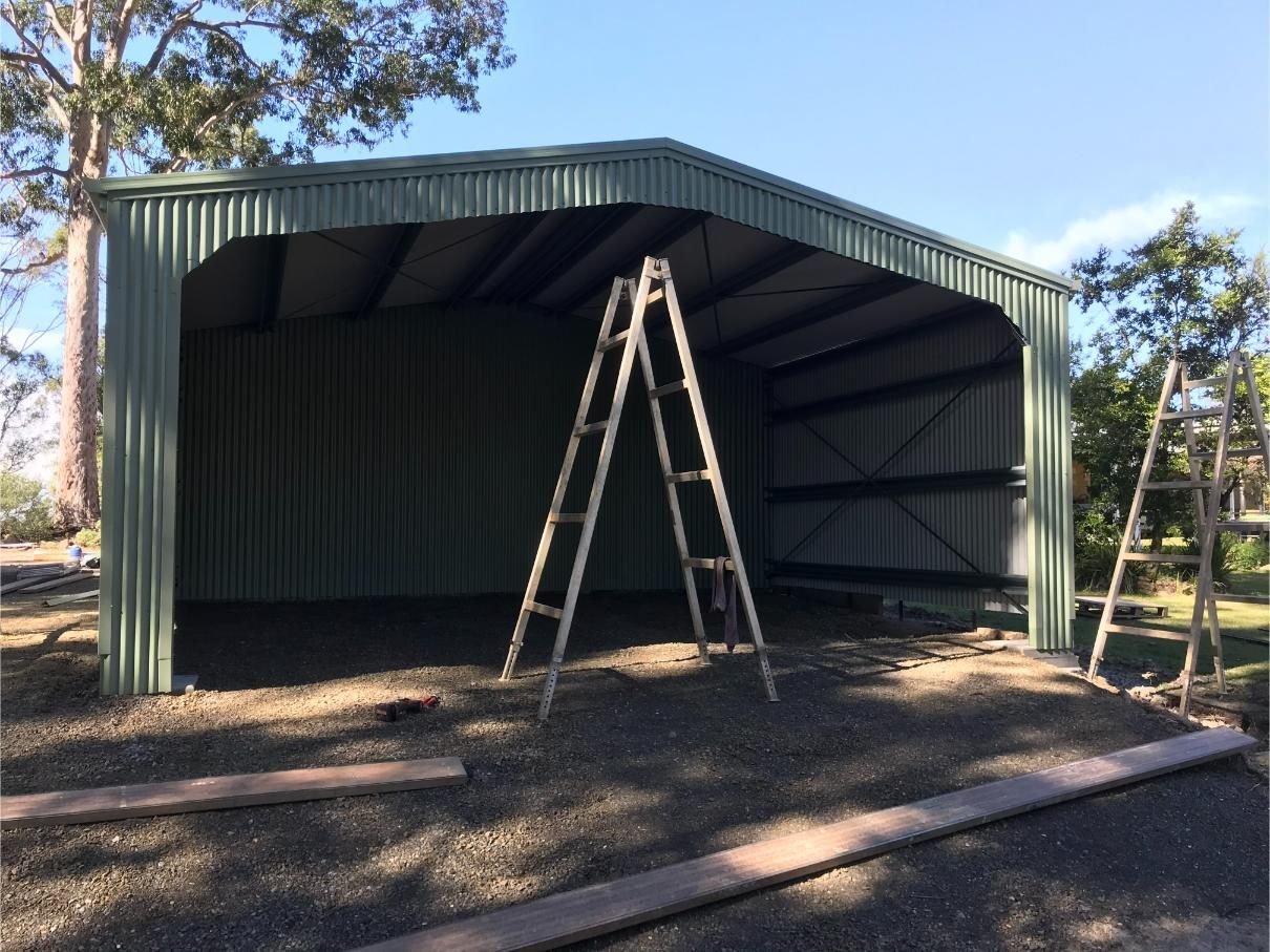A Partially Constructed Green Metal Shed With a Ladder Inside — Bridgey's Constructions in Wallabi Point, NSW
