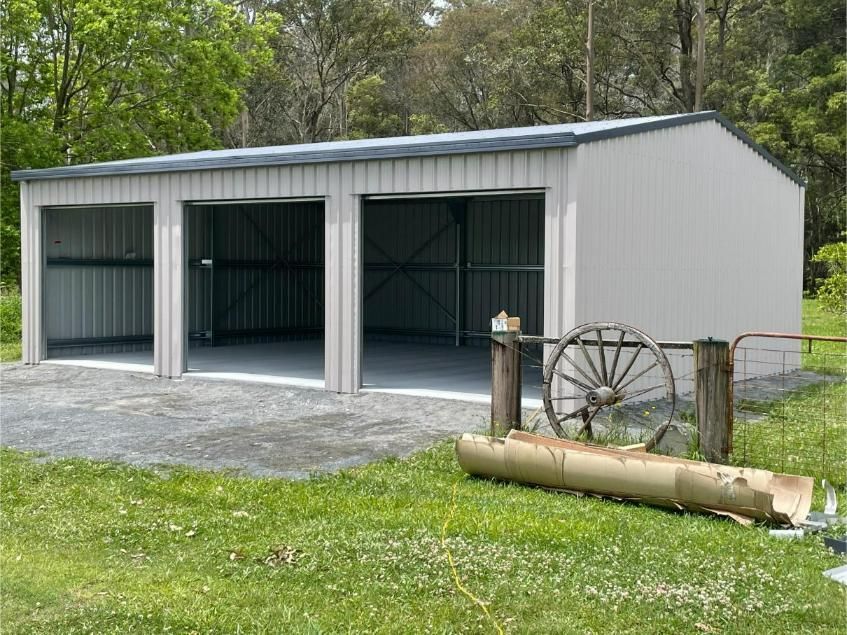 Three-Bay Metal Garage With Open Doors — Bridgey's Constructions in Wingham, NSW