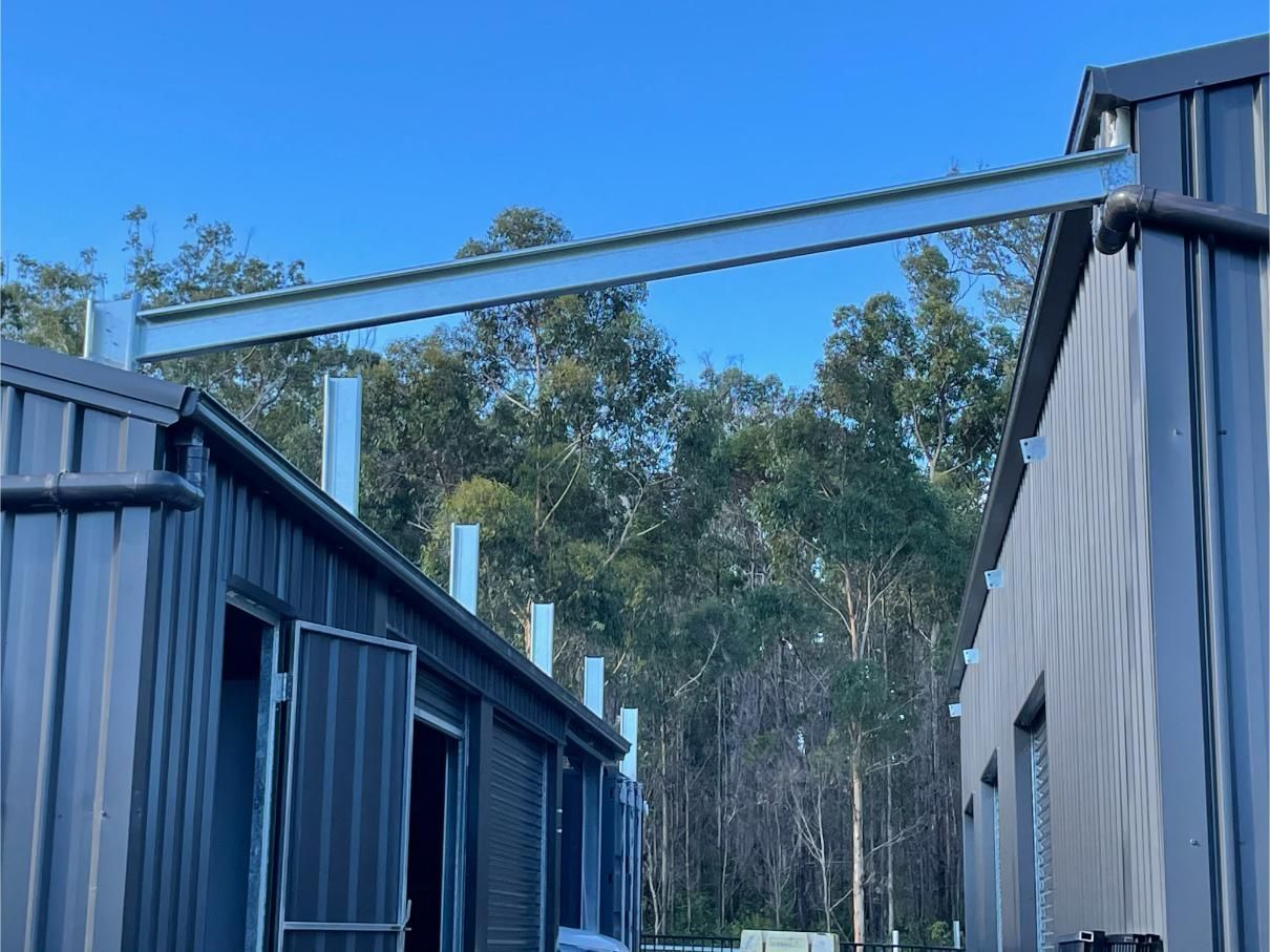 Two Grey Buildings Connected by a Steel Beam Overhead — Bridgey's Constructions in Harrington, NSW