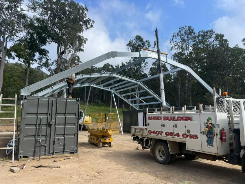 Workers Assembling a White Metal Frame Structure Beside a Truck — Bridgey's Constructions in Wallabi Point, NSW