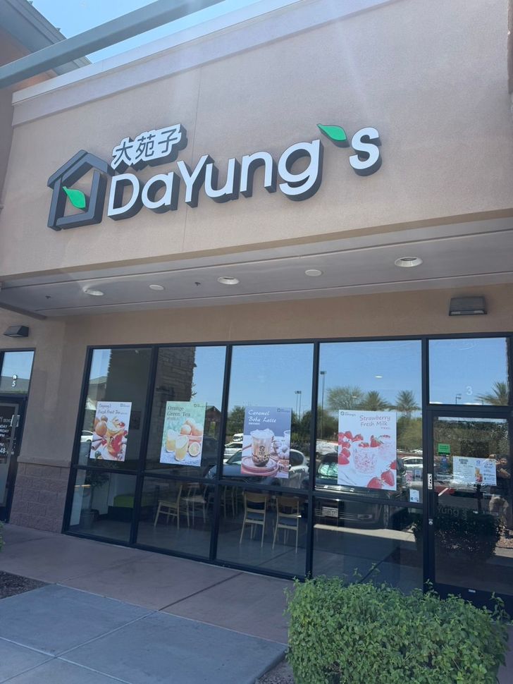 Dayung’s storefront with glass doors, tan facade, and sign above the entrance