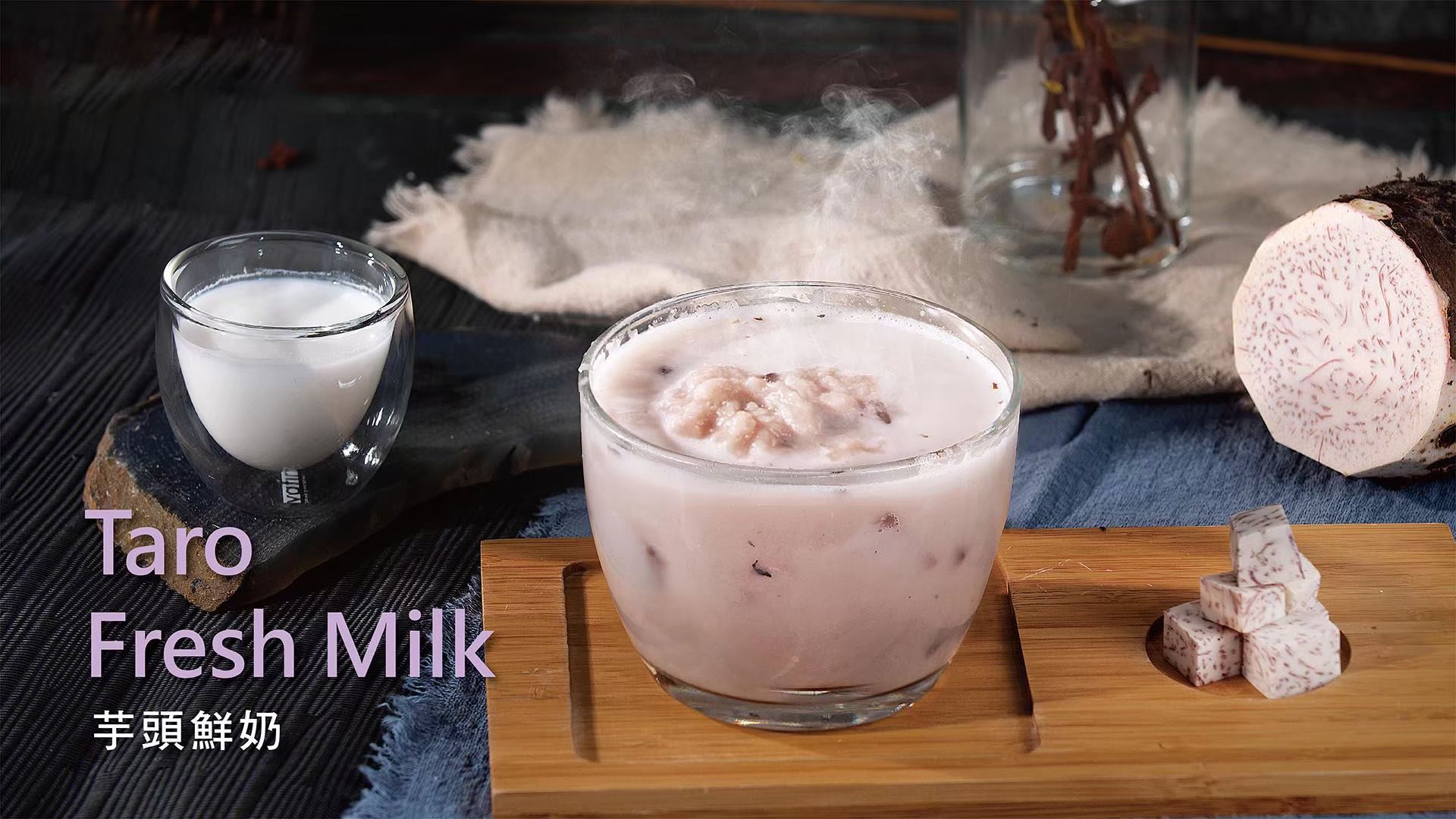 Taro fresh milk in glass cups with taro cubes on a wooden board, set in a rustic table scene.