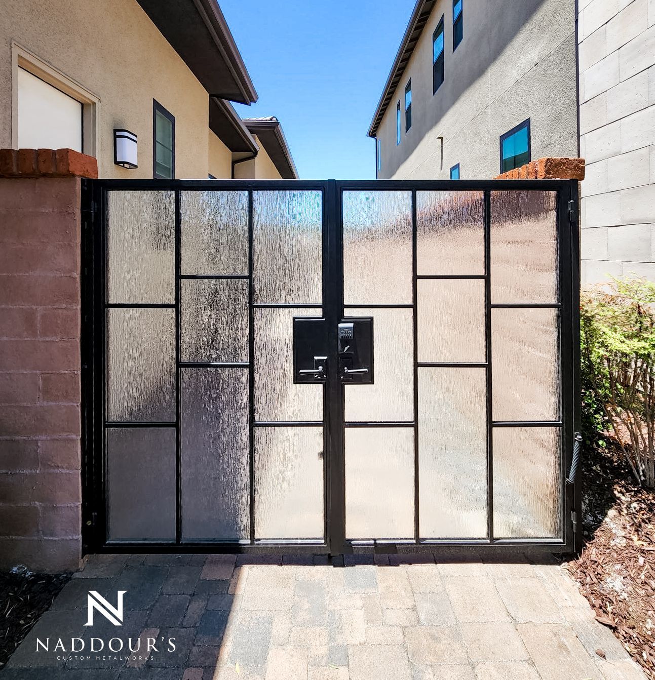 A black gate with the letter n on it