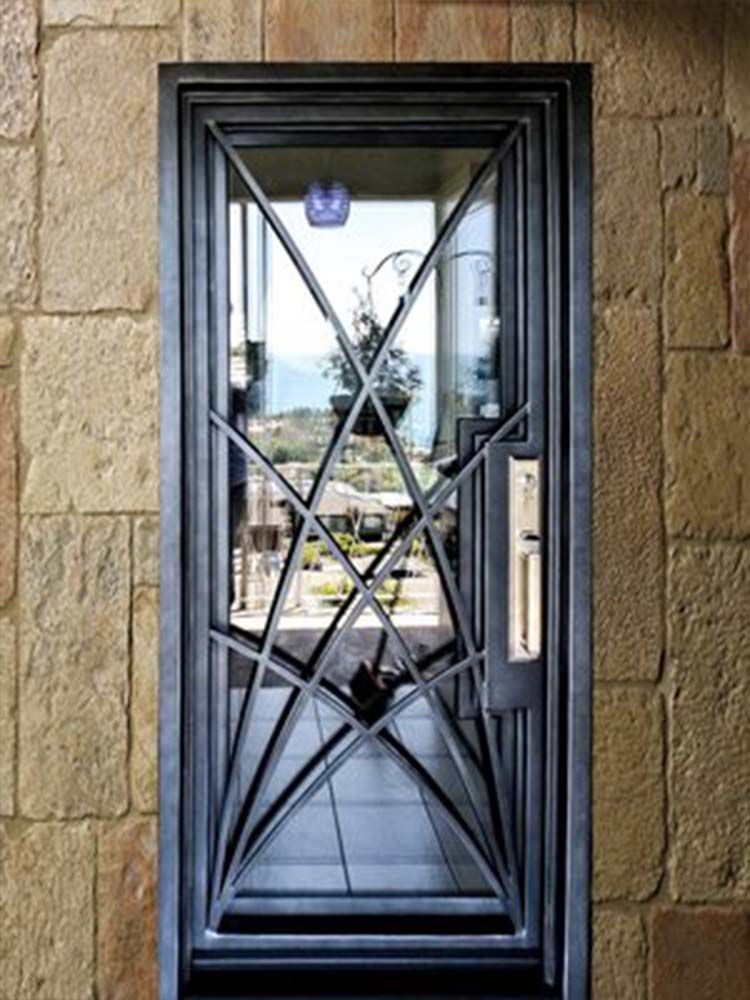 A wrought iron door with a glass window is on a wall.