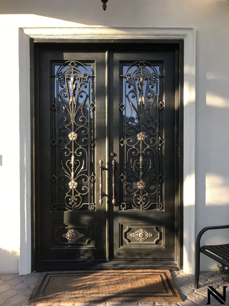 A black door with a wrought iron design on it