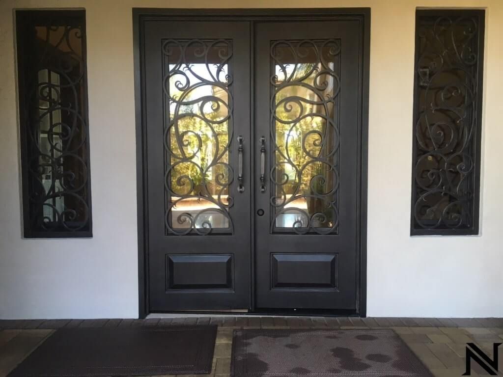 The front door of a house has a wrought iron design on it