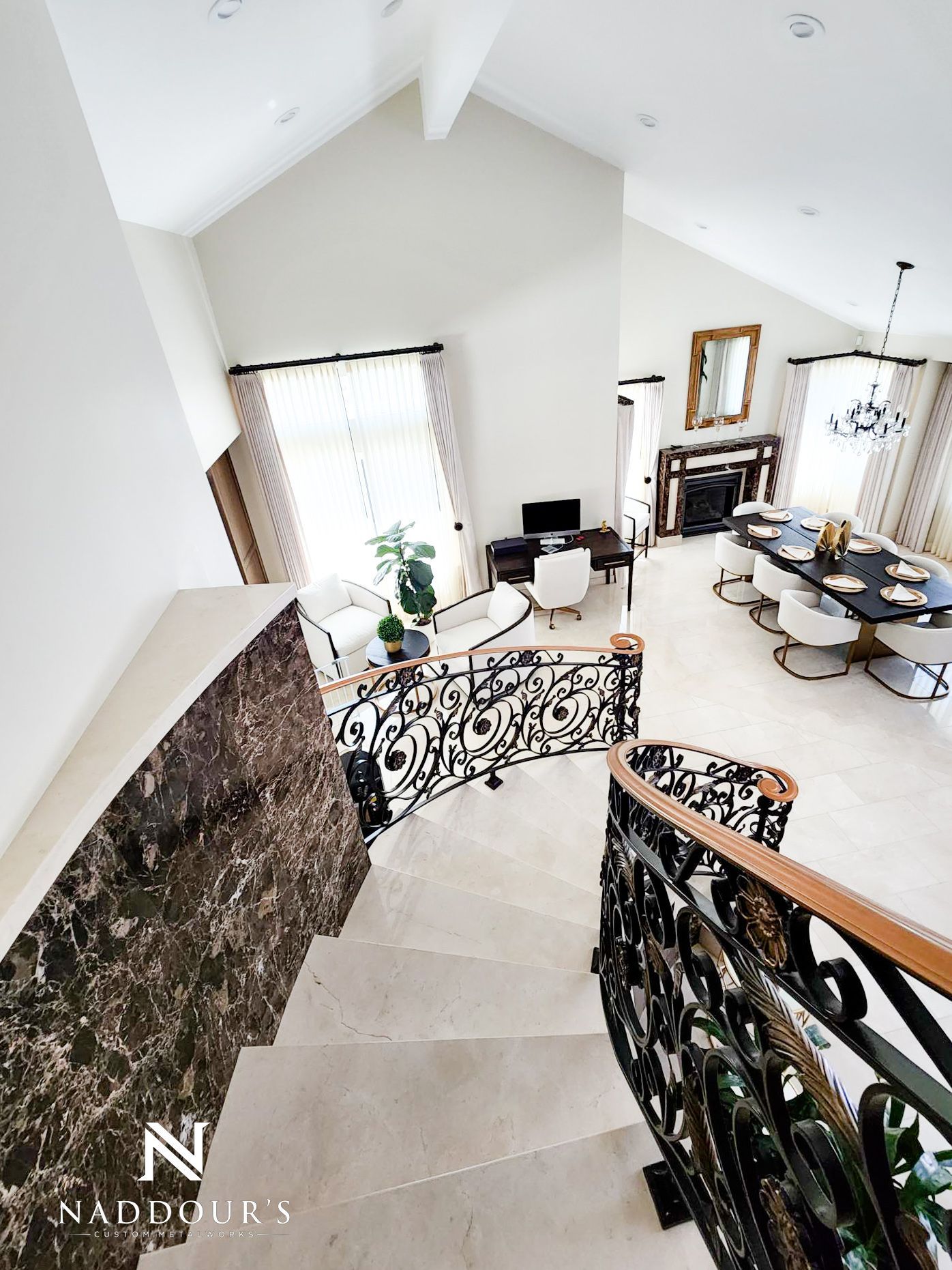 A staircase leading up to a living room and dining room in a house.