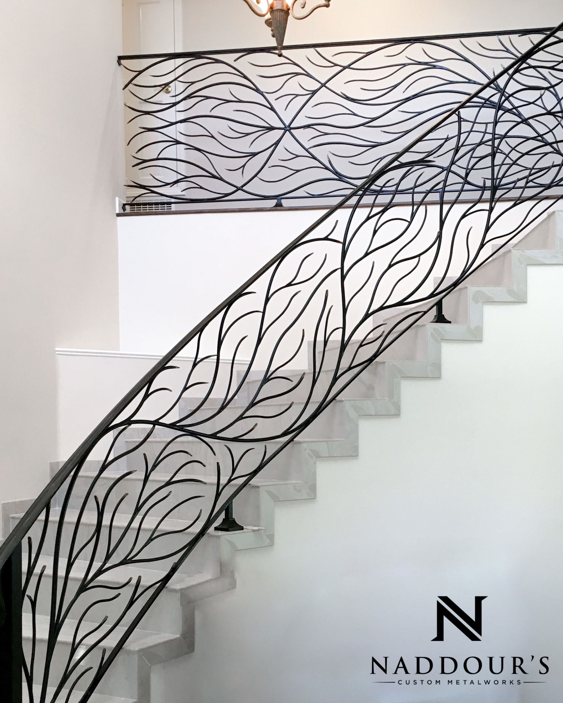 A staircase with a wrought iron railing by naddour 's