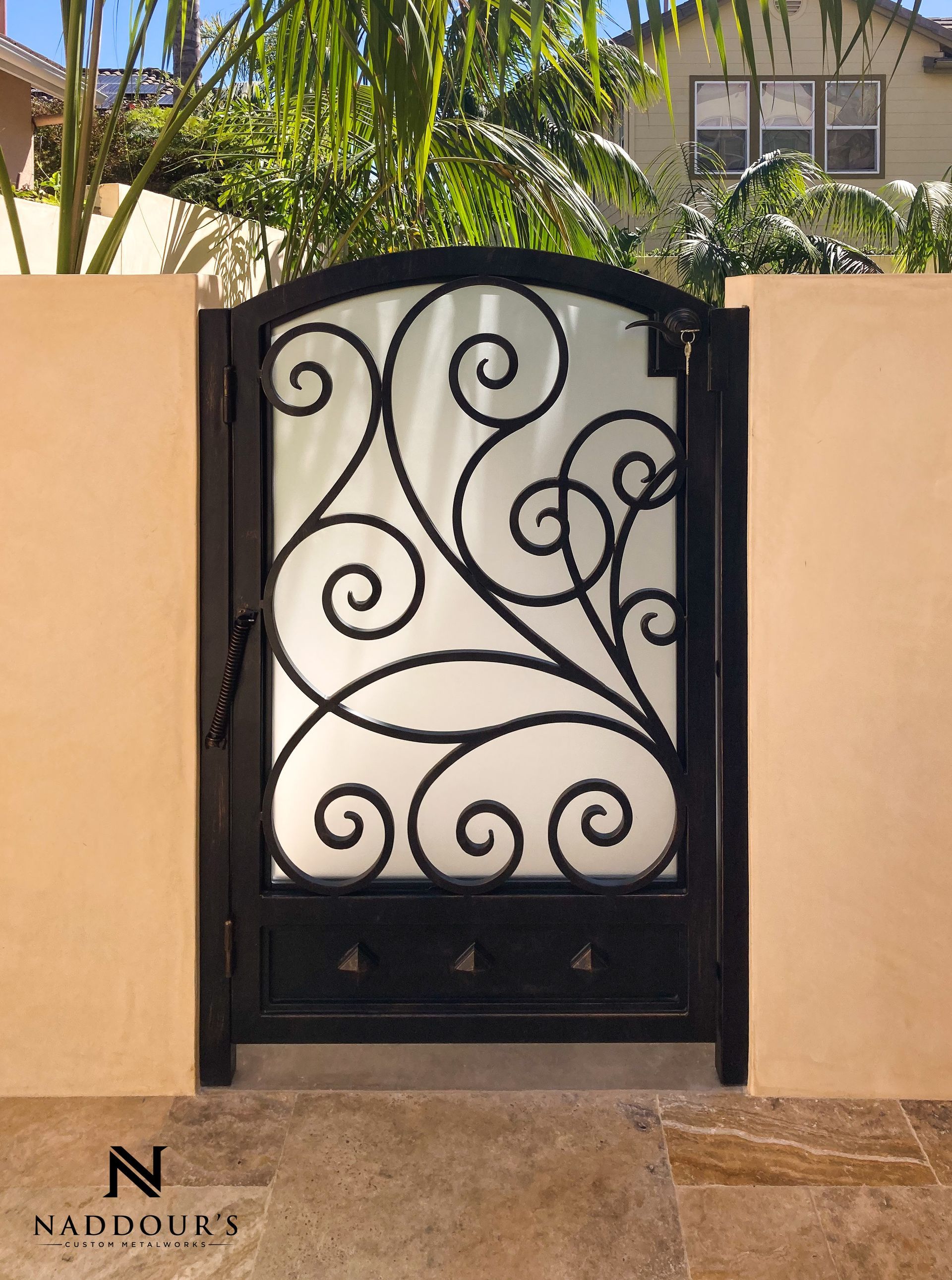 A wrought iron gate with a swirl design on it