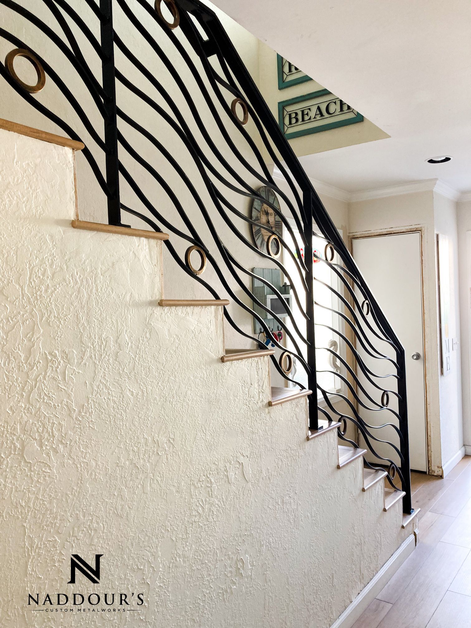 A staircase with a wrought iron railing in a house