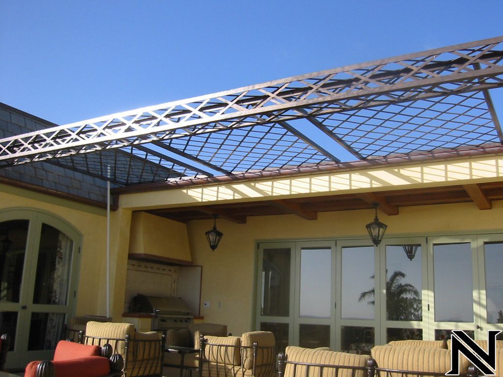 A patio with a roof that has a n on it