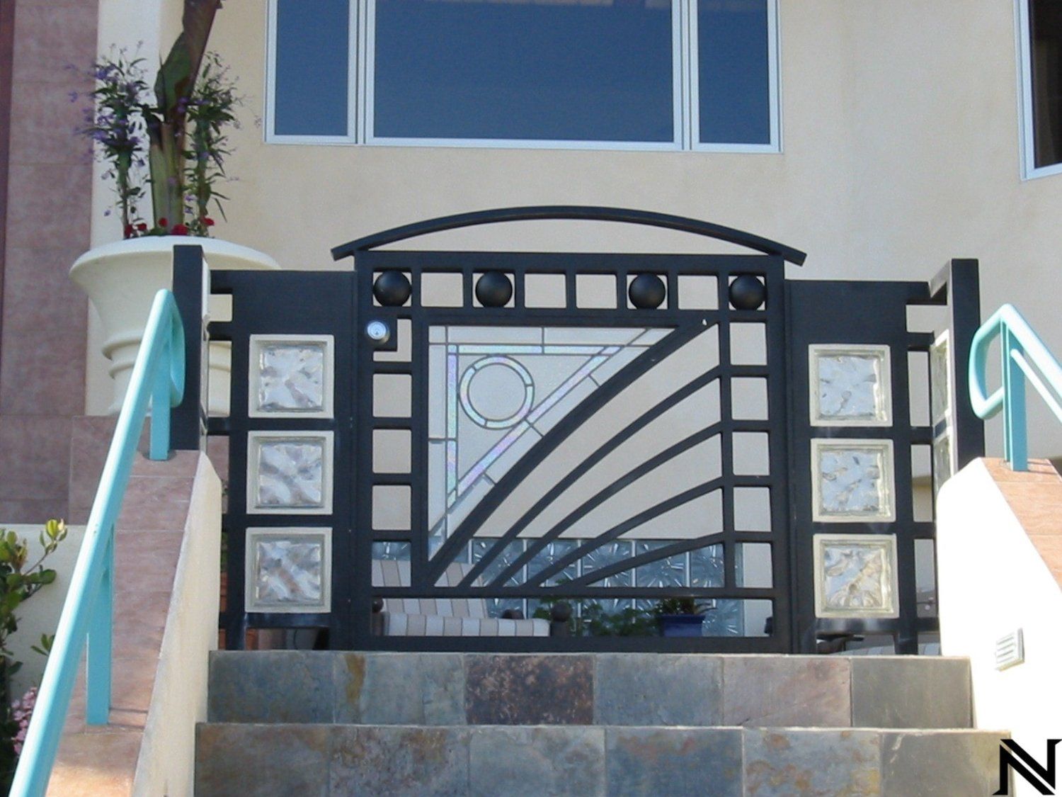 A house with stairs and a gate that says n on it