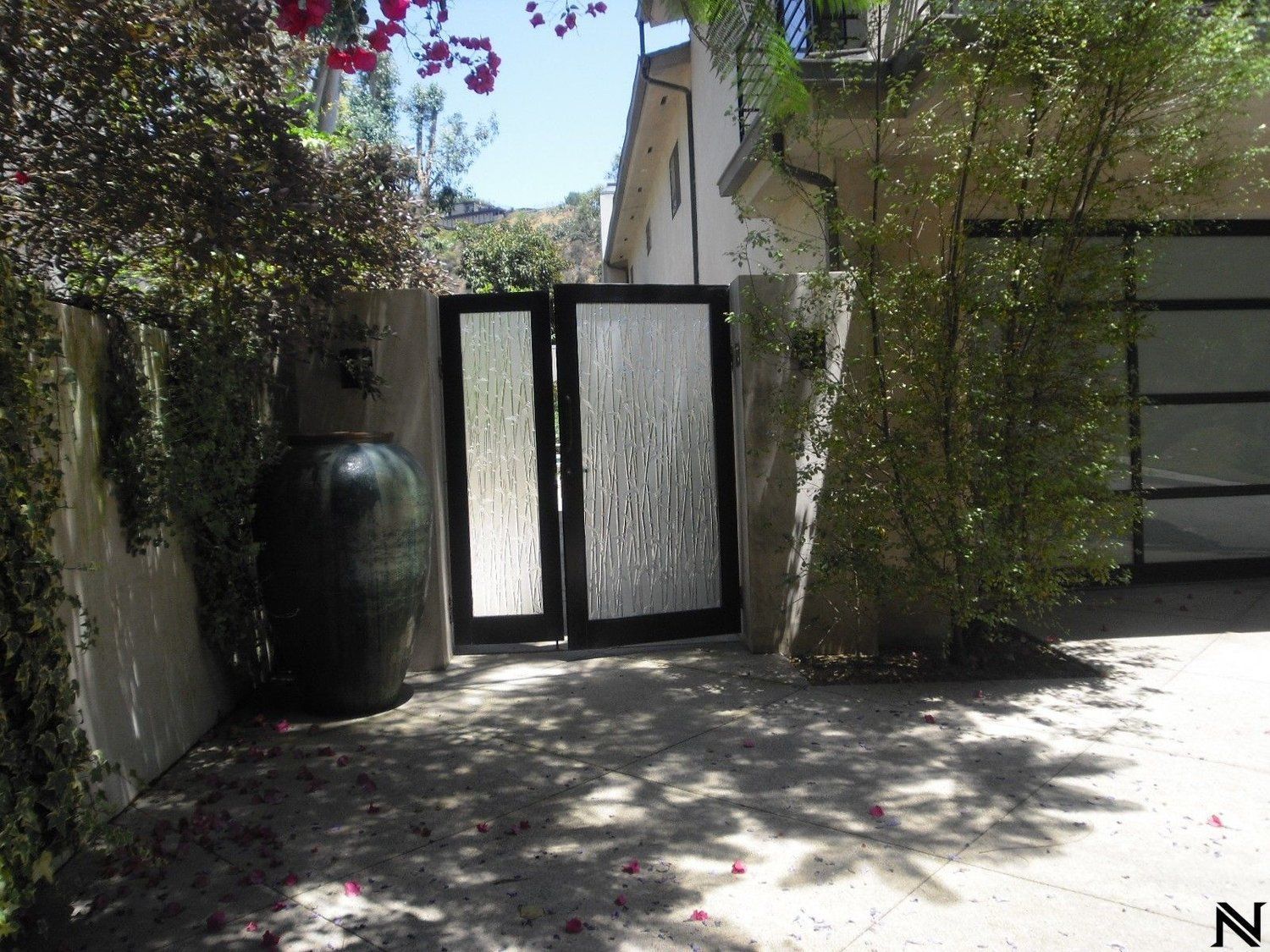A house with a fence and a gate that says n on it