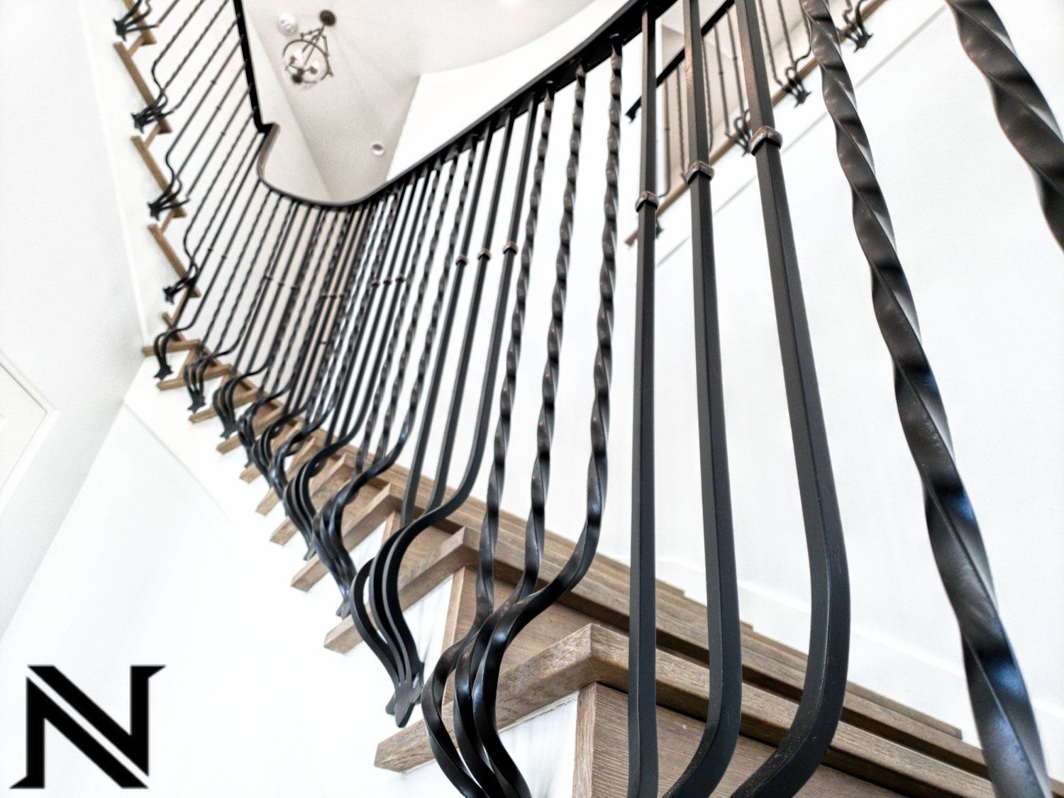 A close up of a wrought iron railing on a staircase