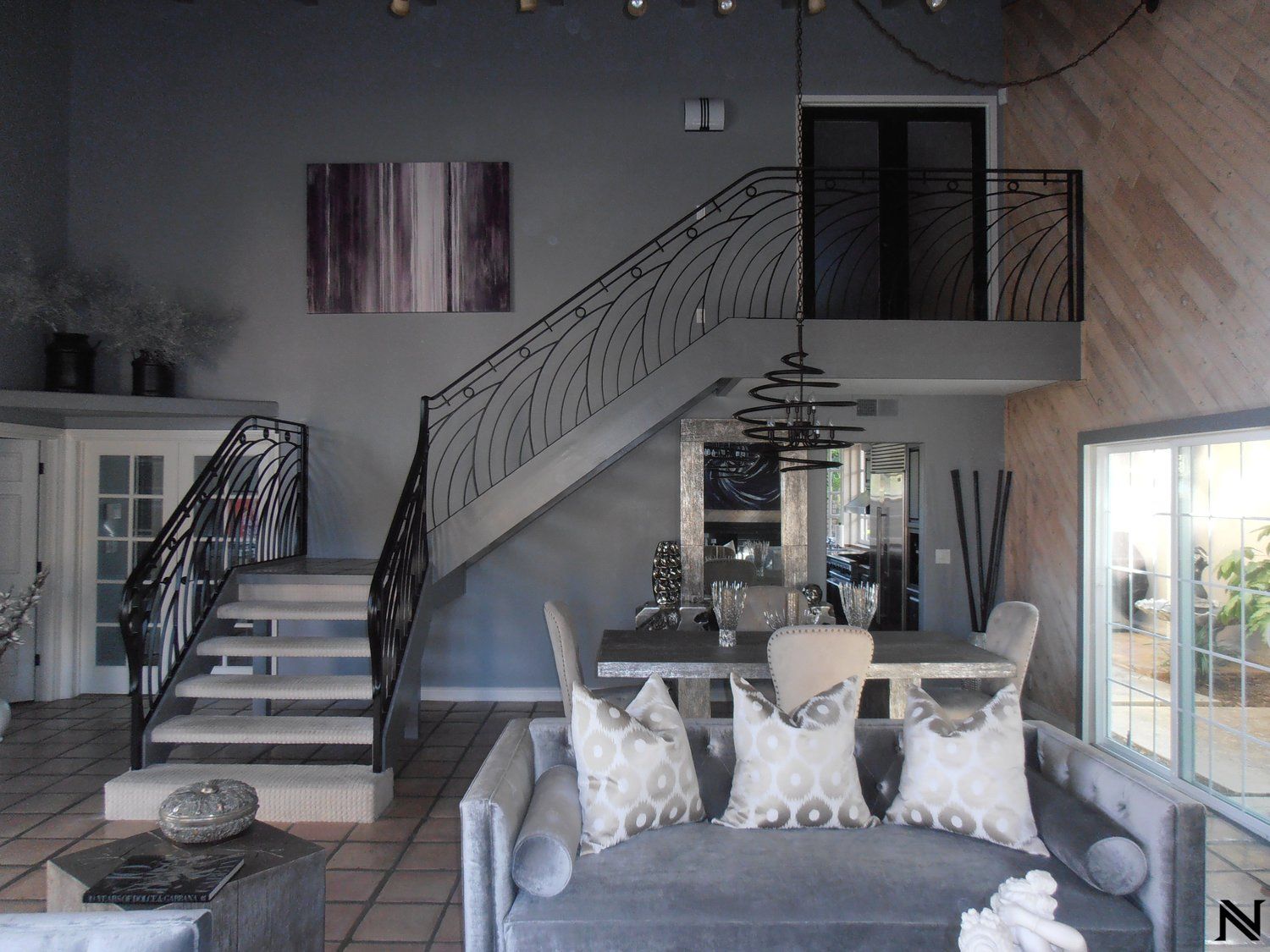 A living room with a couch and stairs leading up to the second floor