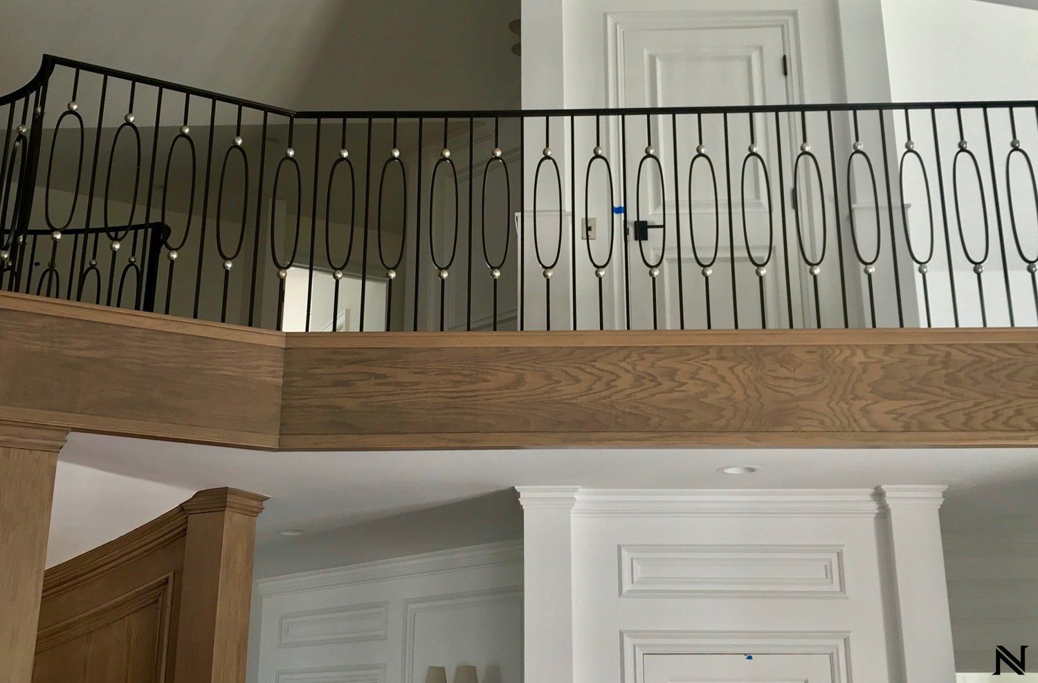 A balcony with a wrought iron railing in a house