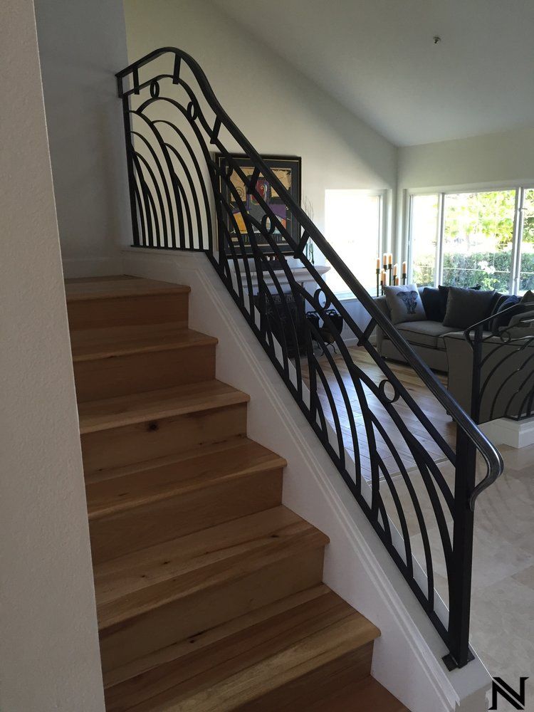 A staircase with a wrought iron railing in a living room