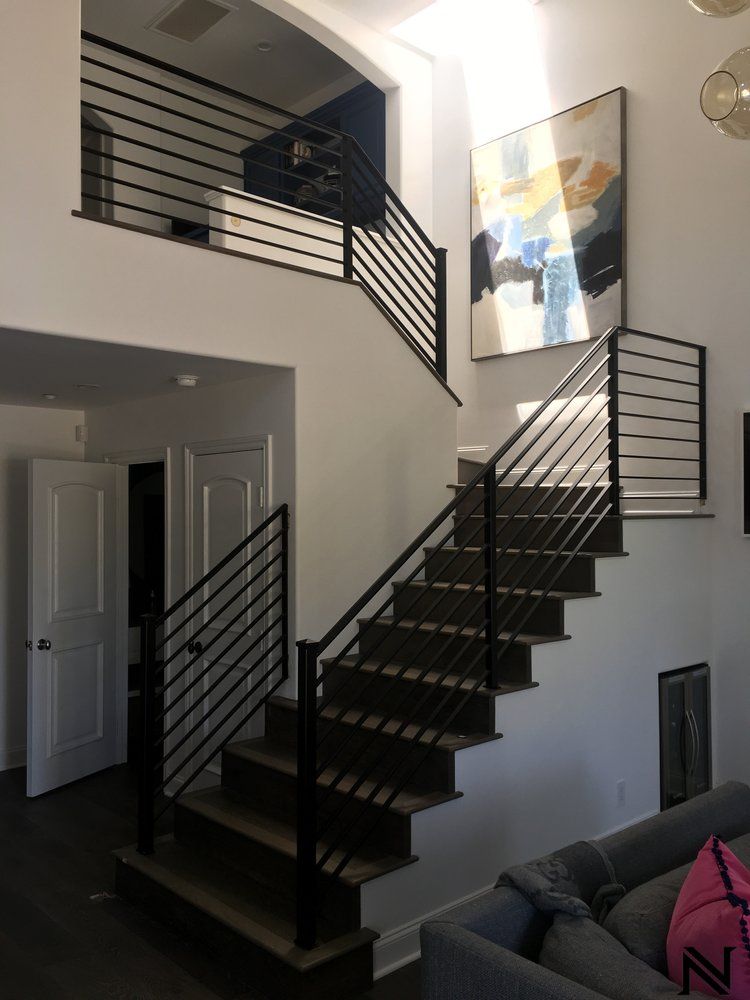 A living room with stairs leading up to the second floor