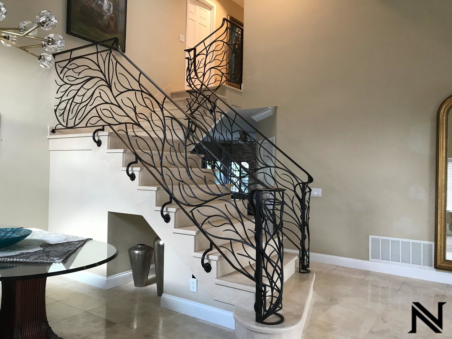 A staircase with a wrought iron railing in a house