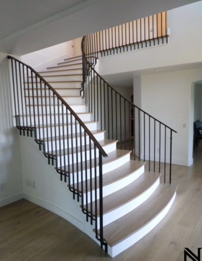 A staircase in a house with a metal railing